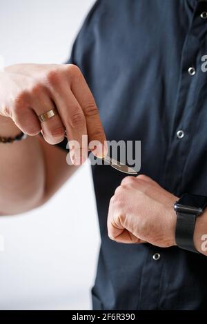 Doctor specialist holds a metal surgical scalpel in his hands Stock Photo