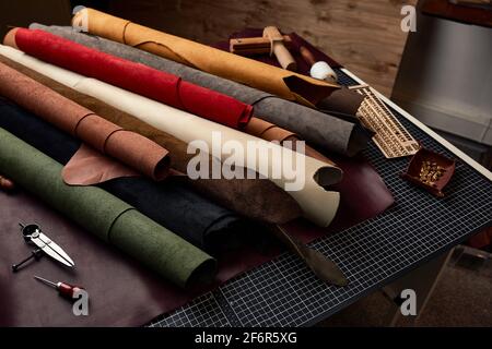 Artificial leather samples on a cow leather background. Top view Stock Photo