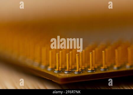 Close-up of a processor's pins on a wooden table. Selective focus. Stock Photo