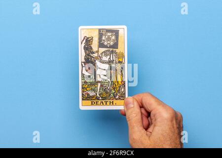 Hand holding the Death tarot card. Stock Photo