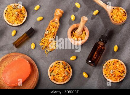 Calendula alternative medicine. Essential oil, soap and pills - Calendula officinalis. Stock Photo