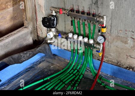 Control panel for hydronic underfloor heating system under leak and pressure test before pipes are covered in self levelling compound Stock Photo