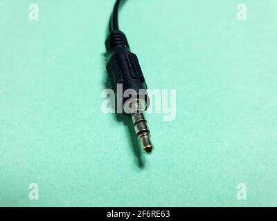 mini jack plug close up on green background Stock Photo