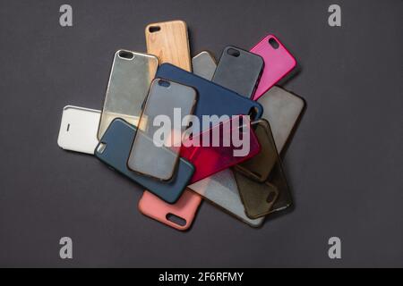Pile of multicolored plastic back covers for mobile phones on black background Stock Photo
