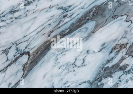 Blue and white marble slab texture of ceramic floor tiles with abstract pattern background. Stock Photo