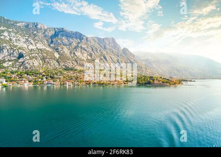 View of the the medieval village of Perast, including the St. Nikola Church tower, along the coast of the Bay of Kotor, Montenegro. Stock Photo