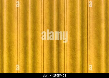 Sliding door, yellow curtain scene from the leather of the conference room in the hotel. Wavy abstract pattern wall texture background. Stock Photo