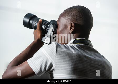young man outdoors photographing something. Stock Photo