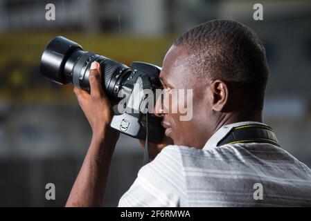 young man outdoors photographing something. Stock Photo