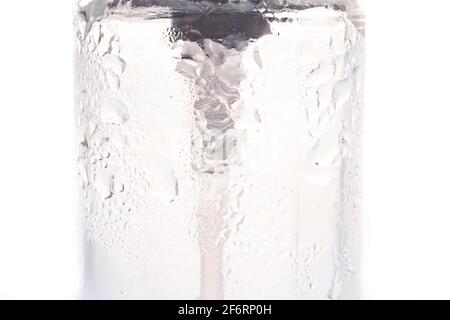 Water drops against the sides of the container. Water on the water storage container. Light background. Stock Photo