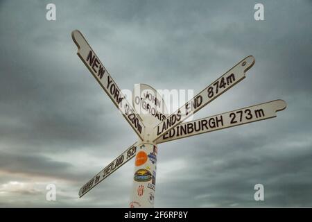 Street sign showing the distances to Lands End, Edinburgh and New York at John O'Groats, the most northerly point of the mainland United Kingdom.