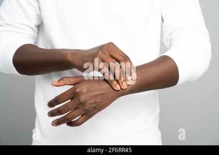 Black man arms holding painful wrist, suffering from carpal tunnel syndrome, arthritis, close up. Stock Photo