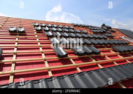 Roofing work, new covering of a tiled roof.