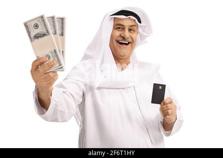 Mature arab man holding stacks of money and a credit card isolated on white background Stock Photo