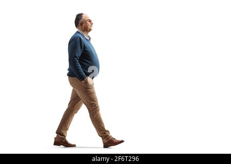 Full length profile shot of a mature man with a big belly walking isolated on white background Stock Photo