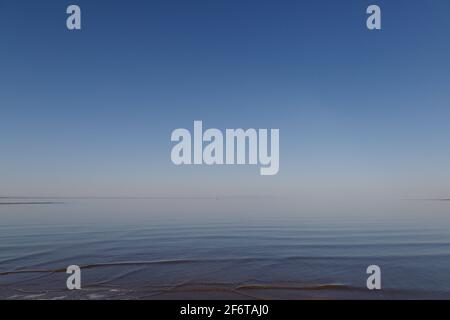 Dramatic stormy dark cloudy sky over sea, natural photo background. Stock Photo