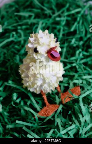 Traditional Easter Decoration, Paper Duckling in paper grass, Still Life, USA Stock Photo