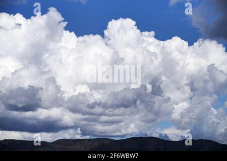 dramatic clouds over distant dark hills Stock Photo