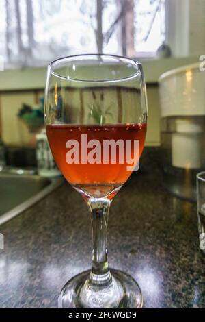 Glass with cool rose wine backlit by window light Stock Photo