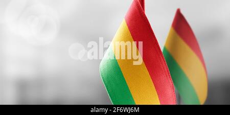 Small national flags of the Bolivia on a light blurry background Stock Photo