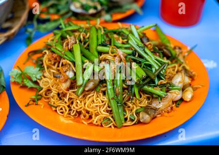 Stir-fried razor clams with noodle and vegetables - Vietnam local seafood Stock Photo