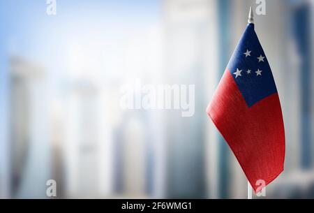 A small flag of Samoa on the background of a blurred background Stock Photo