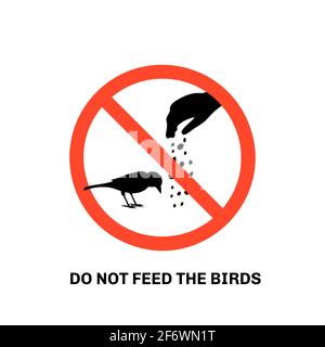 Prohibition sign with text do not feed the birds and hand silhouette giving food to sparrow Stock Vector