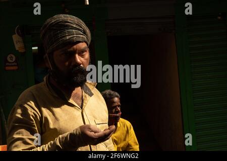K.R.Market, Bangalore, India - February 06,2021: Angry looking young man with beard trying to eat Stock Photo