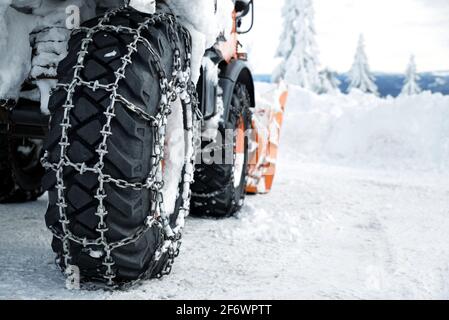 Car wheels equipped with snow chains. Winter season. Stock Photo