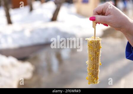 A gnawed cob of freshly boiled corn. Fast food concept. Stock Photo