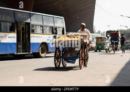 K.R.Market, Bangalore, India - February 06,2021: Muslim street seller on a vehicle during pandemic in K.R.Market Stock Photo