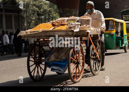 K.R.Market, Bangalore, India - February 06,2021: Muslim street seller on a vehicle during pandemic in K.R.Market Stock Photo