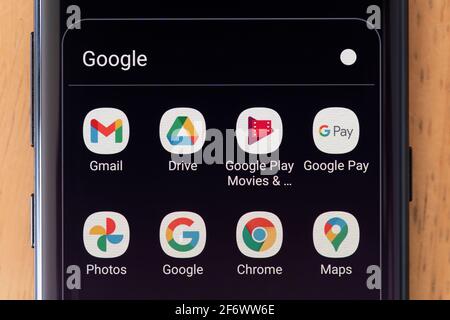 A selection of Alphabet (formerly known as Google) apps on a smartphone screen, including Gmail, Google Drive, Google Pay, Chrome, Google Maps Stock Photo