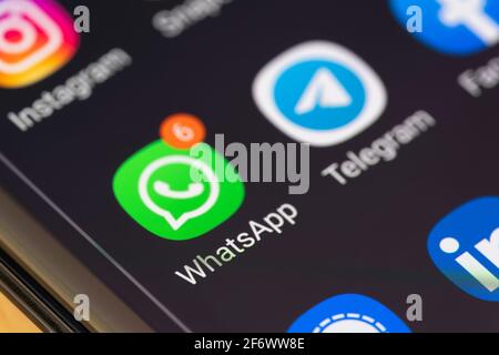 Macro closeup on the WhatsApp icon on a smartphone screen showing alerts / message notifications Stock Photo