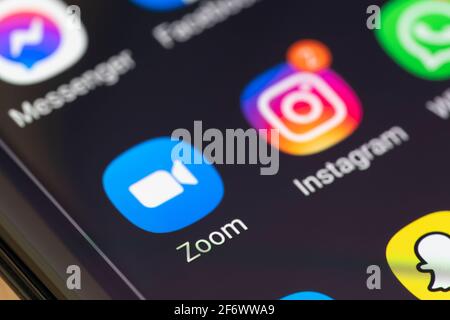 A macro closeup of the Zoom app on a smartphone screen. Zoom is a videotelephony proprietary software program developed by Zoom Video Communications Stock Photo