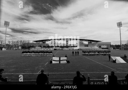 The rugby stadium in Parma, Italy. The teams line up behind their flags prior to a game between England U16s and Italy U17s in 2012..B&W Stock Photo