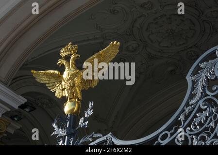A golden Russian Imperial Eagle on top of wrought iron gates at the entrance to the Winter Palace, St Petersburg, Russia. Stock Photo
