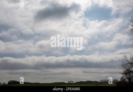 Rolling dark cumulus clouds building up in sky threatening rain, Wiltshire, England, UK Stock Photo