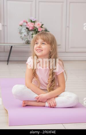 Full length front view smiling cute playful little preschool girls sitting  on on yoga mat do various exercises. Happy kids practicing yoga exercised a  Stock Photo - Alamy