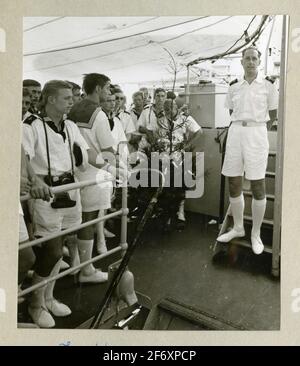 The picture represents the mincaft's river's crew, participate in a Christmas prayer dressed in summer uniforms during the long journey 1966-1967 .. The picture represents the miner boat's crew, participate in a Christmas prayer dressed in summer uniforms during the long journey 1966-1967.Included in albums with photographs from Älvsnabben's long journey 1966-1967.She declined 10/11 1966 from Karlskrona and went through the Suez Canal to Australia, US West Coast, through the Panama Canal via Dublin home to Marstrand 6/5 1967. The album contains images on board and on the visits you made in lan Stock Photo