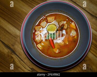 Overhead view of a bowl of hot curried Sweet Potato and Shrimp Soup Stock Photo