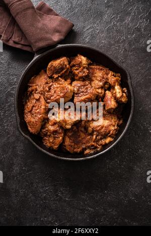 Meat Stew. Beef stewed in red wine sauce, top view, copy space. Slow cooked braised meat in cast iron pan. Stock Photo