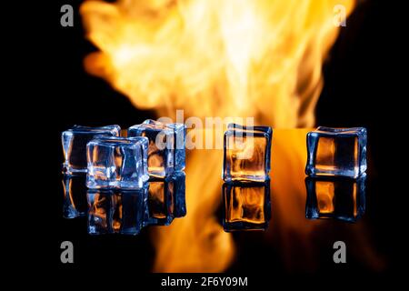 ice cubes on a black background in flames Stock Photo