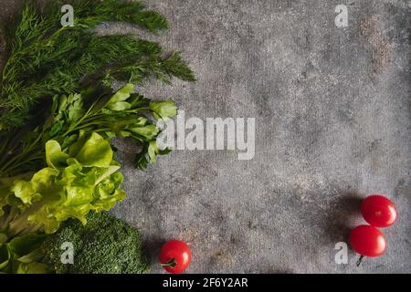 Broccoli and tomatoes on gray background Stock Photo
