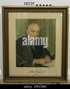 Photography.Photography in glass and frame, colored, depicting Prime Minister Per Albin Hansson sitting at desk.Halffold with gaze directed at the camera.Clothing dark jacket, blue shirt and patterned tie. The background bleached green, on the desk paper.Signed in white in the lower, left corner. The pressure is equipped with white edge and pressure: "Vepettryck Stockholm".At the bottom signed: "P Albin Hansson" .Ram of wood, profiled, painted in gold, B = 40 mm back dressed with brown cardboard on which it was written with pencil: "Drawings are included".When the paper was removed, two more p Stock Photo