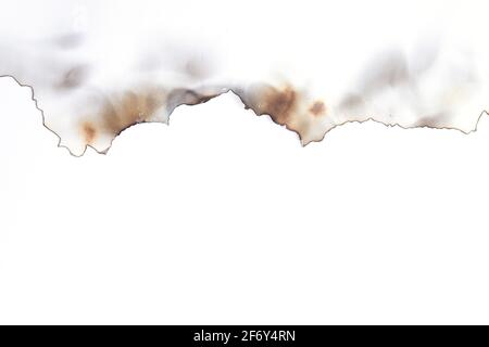 Burnt old torn paper isolated on white background with copy space Stock Photo
