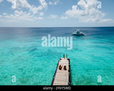 Playa Kalki Curacao tropical Island in the Caribbean sea, Playa Kalki western side of Curacao Caribbean Dutch Antilles azure ocean, drone aerial view of couple men and woman on the beach from above Stock Photo