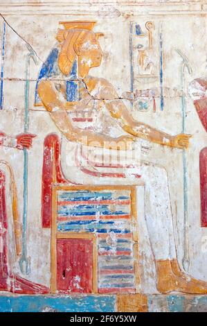 An Ancient Egyptian carved hieroglyphic painting of the goddess Mut. One of the symbolic mothers of the king, she is shown with a vulture headdress. W Stock Photo