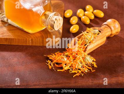 Calendula capsules. Alternative Medicine - Calendula officinalis Stock Photo