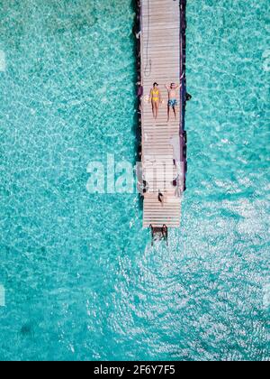 Playa Kalki Curacao tropical Island in the Caribbean sea, Playa Kalki western side of Curacao Caribbean Dutch Antilles azure ocean, drone aerial view of couple men and woman on the beach from above Stock Photo